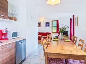 A modern kitchen with a dishwasher, microwave, and red coffee maker. - Green Valley Park Stárkov 18 by Interhome (Stárkov)