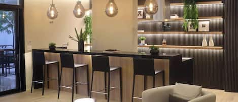 A modern interior with a bar area, seating, and a view through a large window.