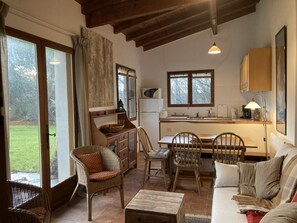 A cozy interior with a dining area, kitchen, and seating space. - Epona's House - LABATUT (LABATUT)