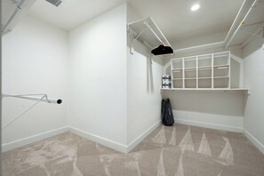 A clean, white room with a built-in storage unit and a ceiling vent. - Spacious 5-bedroom house fully Furnished Private Pool – Extended Stays Welcome (Scottsdale)