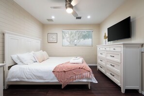 A bedroom with a bed, a dresser, a television, and a window with blinds. - Spacious 5-bedroom house fully Furnished Private Pool – Extended Stays Welcome (Scottsdale)