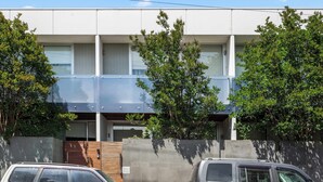A modern two-story building with a flat roof, large windows, and a covered outdoor area. - Arcady, Norwood Townhouse Near The Parade and City (Norwood)
