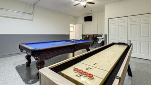 A room with a pool table, a shuffleboard table, and a ceiling fan. - 639 - Stylish and newly renovated 6 Bedroom Home 5 Star (Davenport)