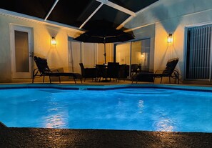 An indoor swimming pool with lounge chairs and a table, surrounded by walls with light fixtures. - 641 Fabulous 4 bed Villa in Conservation Area with Water View (Davenport)