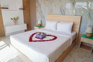 A hotel room with a large bed, a wooden headboard, white bedding, and a marble-patterned wall. - Private 2BR Villa & Pool - Rice Field Views - Canggu (Dalung)