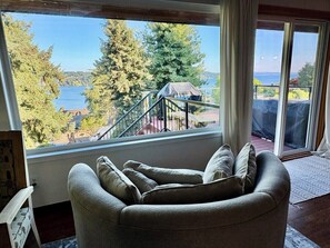 Ein Zimmer mit einem großen Fenster, das einen Blick auf eine Treppe und Bäume bietet.