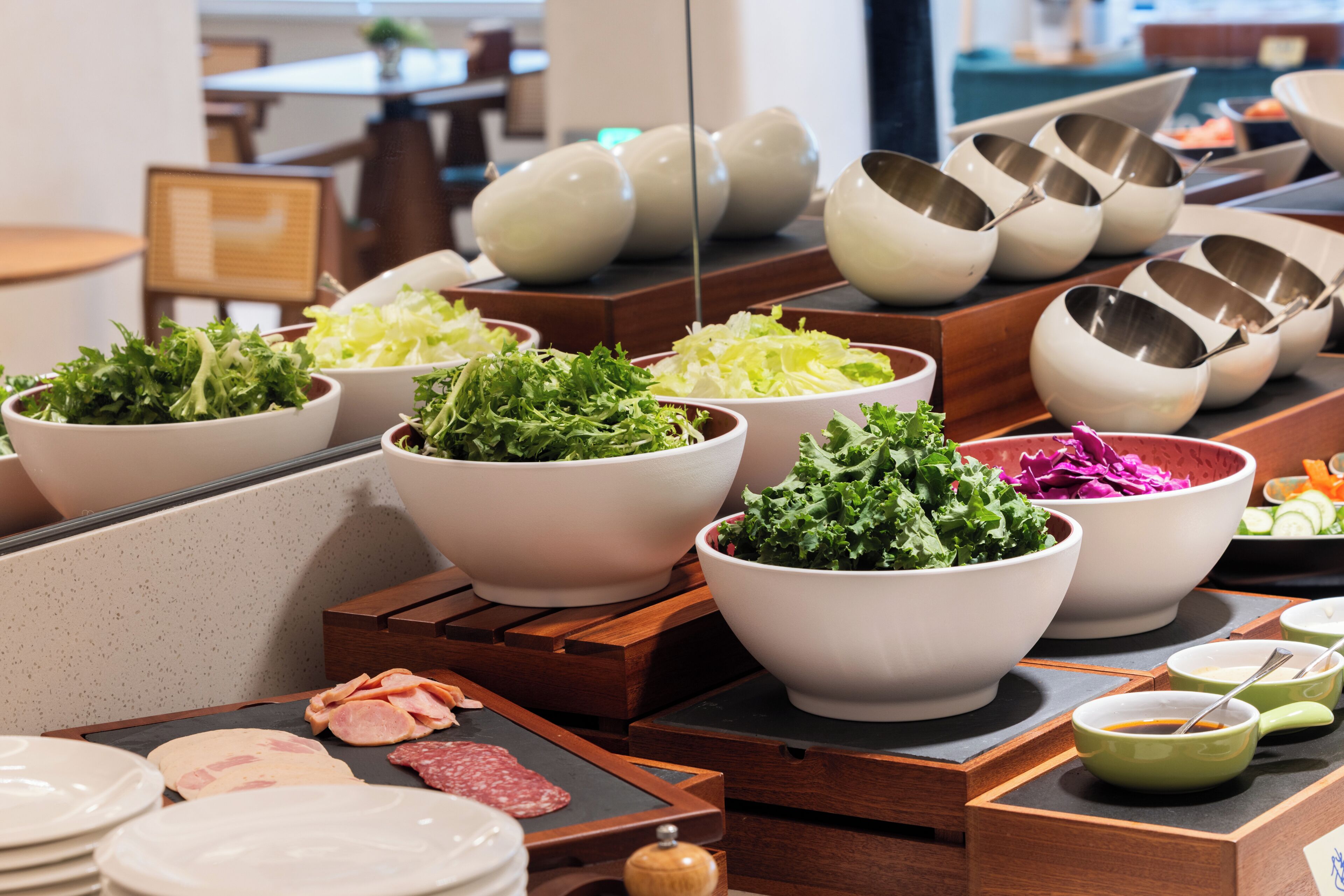 A buffet with various food items and bowls.