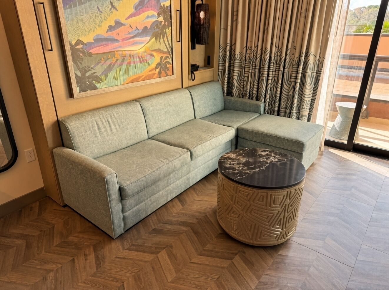 A modern living room with a sofa and a round coffee table.