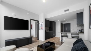 A modern living room with a flat-screen TV, a coffee table, and seating. - Luxury E11EVEN | Skyline Views & Resort Amenities (Miami)