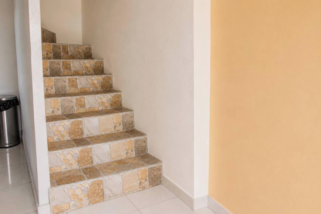 A staircase with stone steps leading to a higher floor.