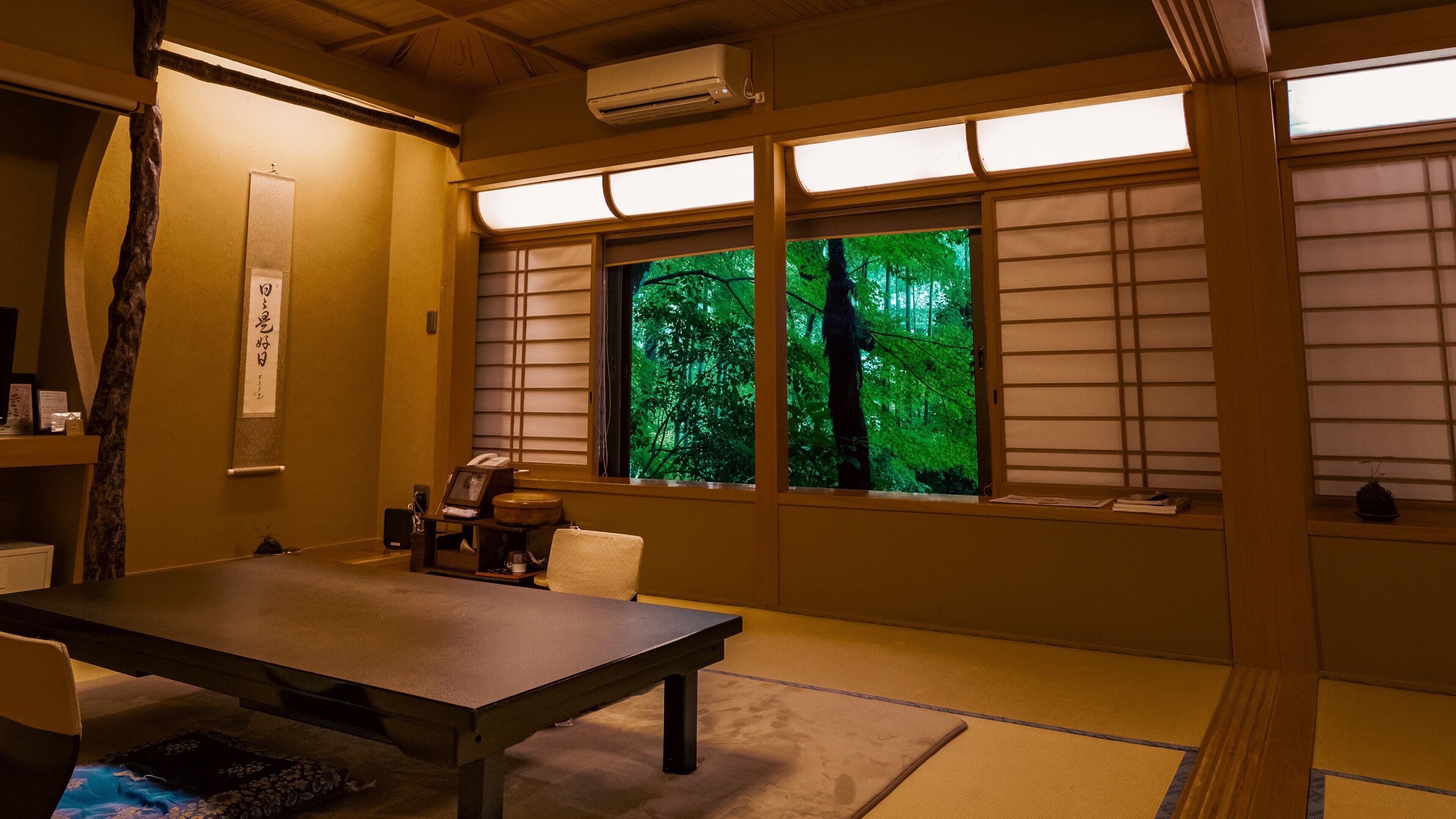 A traditional Japanese room with tatami flooring, a low table, and sliding shoji doors.