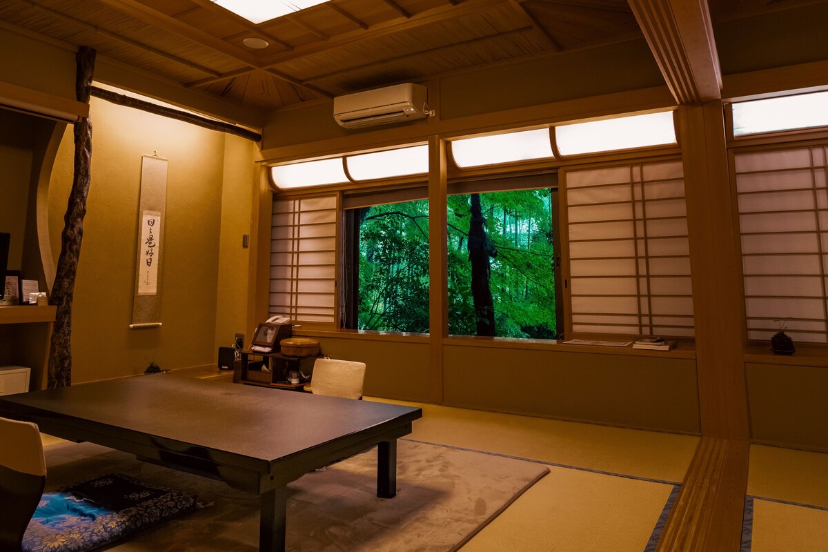 A traditional Japanese room with tatami flooring, a low table, and sliding shoji doors.