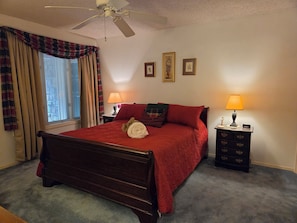 A bedroom with a bed, two bedside tables, a ceiling fan, and a window with curtains. - West Gate Retreat 3 bedroom home near Desoto Golf Club in Hot Springs Village (Hot Springs)