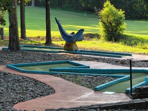 A landscaped area with a sculpture, pathways, and a grassy field. - West Gate Retreat 3 bedroom home near Desoto Golf Club in Hot Springs Village (Hot Springs)