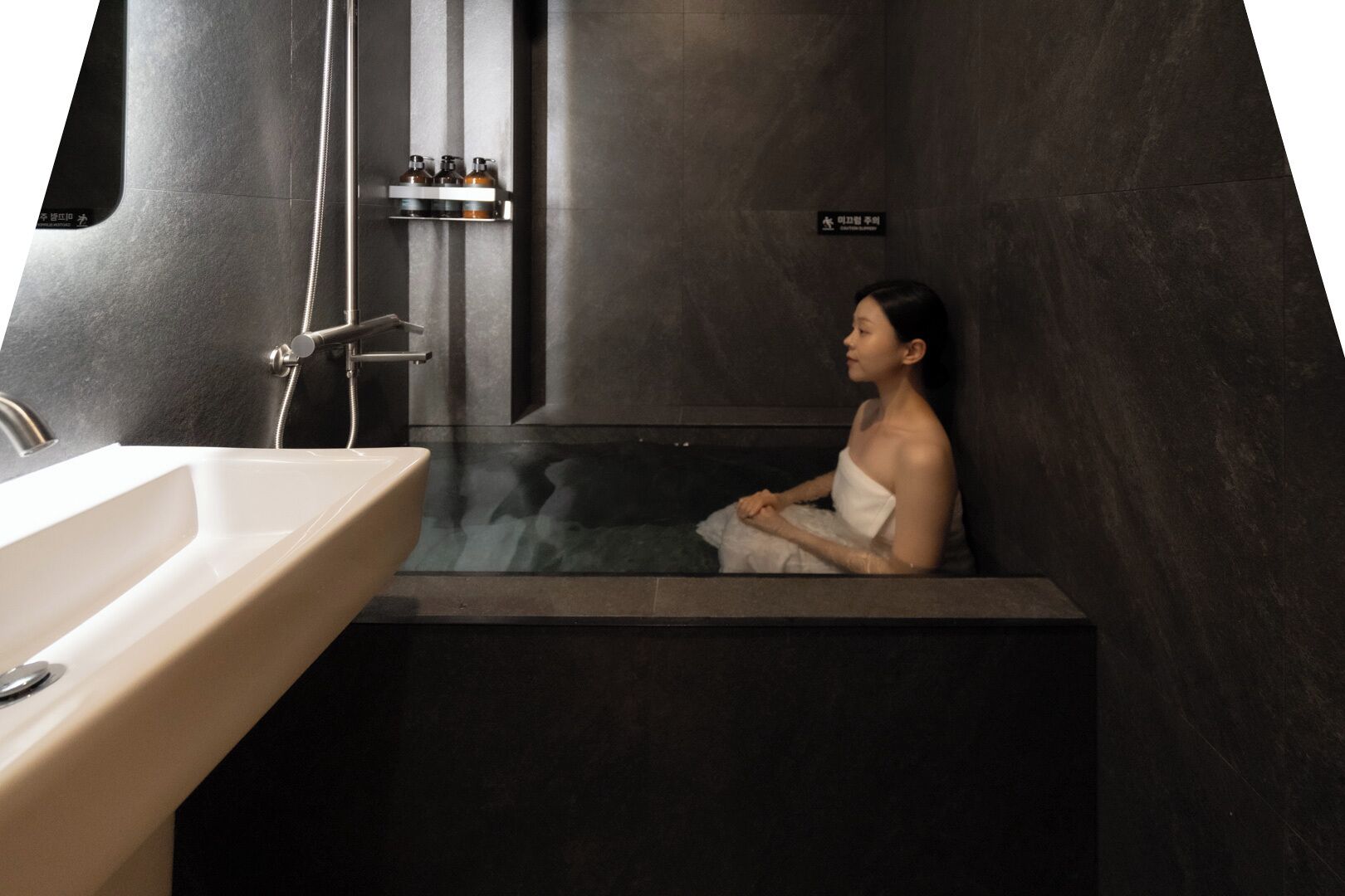 A modern bathroom with a bathtub, a sink, and a shower.