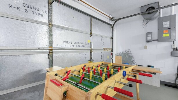 A foosball table in a room with white walls and a visible electrical panel. - Heated Pool No Extra Fee ! firepit| Game Room (Palm Coast)