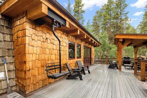 A wooden deck with outdoor seating and a covered area. - NEW lodging experience like no other (Breckenridge)