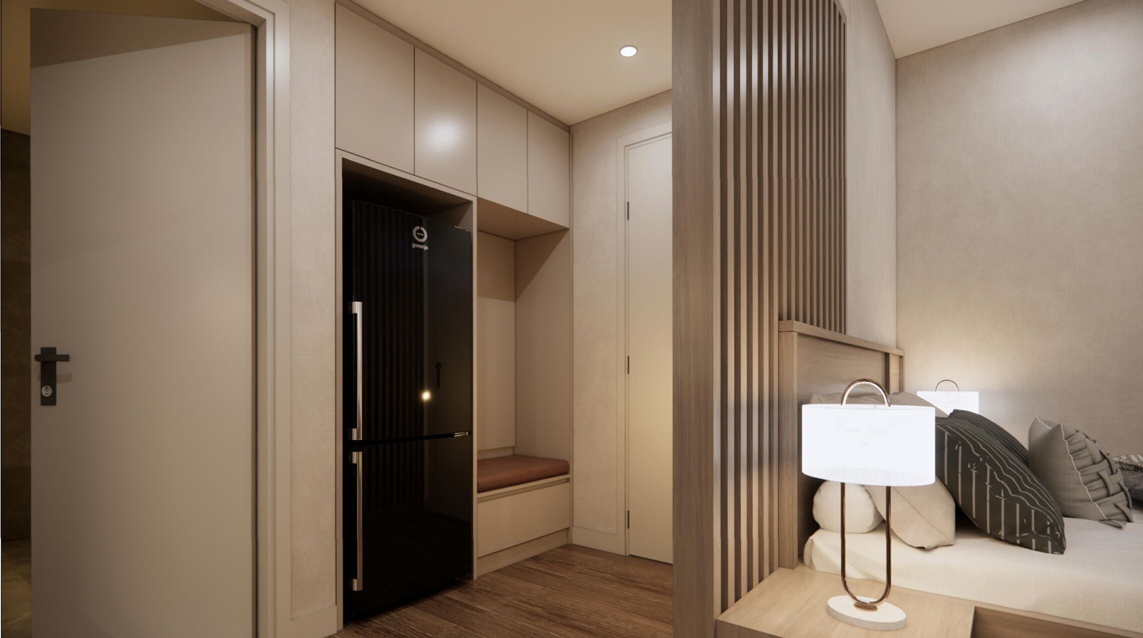 Un interior moderno con un refrigerador negro empotrado, una zona de estar con sofá y cojines, y piso de madera.