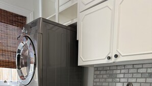 A kitchen with a stainless steel sink, a built-in oven, and a dishwasher.