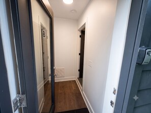A hallway with a door marked 'B', a vent, and a light fixture on the ceiling. - Nashville 1BR • Private Entrance • King Bed (Nashville)