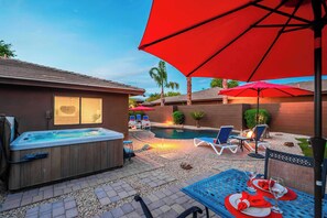 A backyard with a hot tub, a swimming pool, lounge chairs, and a dining area with a table set for two. - "The Ultimate" 1.3 Acre! Guesthouse & Massive Pool! Pickleball & Putting Greens! (Gilbert)