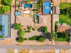 An aerial view of a property with a swimming pool, tennis court, and landscaped areas. - "The Ultimate" 1.3 Acre! Guesthouse & Massive Pool! Pickleball & Putting Greens! (Gilbert)