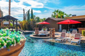 A swimming pool with lounge chairs and a gazebo. - "The Ultimate Escape" over 1 Acre w/ Massive Pool!  Pickleball, & Putting Green! (Gilbert)