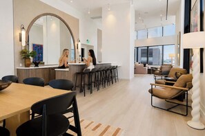 A modern interior with a bar area, seating, and a large mirror. - Luxury 1BR Condo in Downtown Miami | Sleep 4  | Free Parking (Miami)