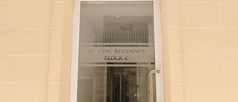 A building entrance with a sign reading 'TA CENC RESIDENCE BLOCK C'.
