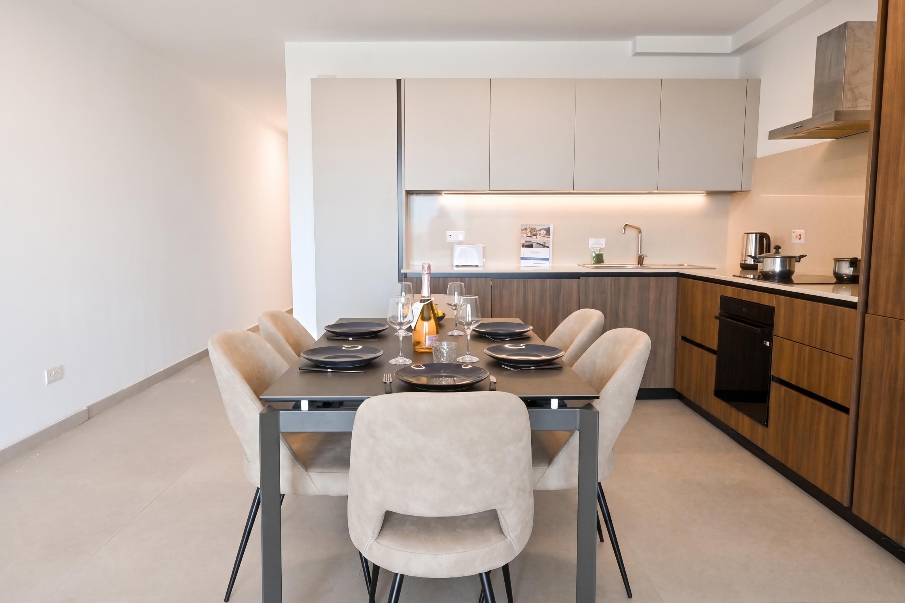 A modern kitchen with a dining area.