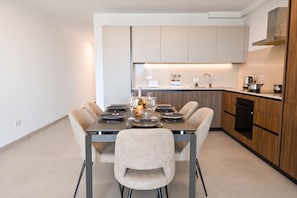 A modern kitchen with a dining area. - Pool And Sea - Modern Apart Sannat Gozo (Sannat)