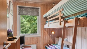 A compact room with a bunk bed, a desk with a computer, a window with a view of greenery, and a radiator. - "Tarvo" - 500m to the fjord by Interhome (Løgstør)