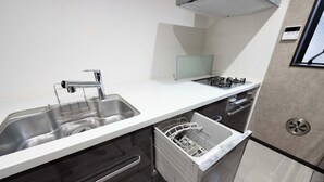 A modern kitchen with stainless steel appliances, a dishwasher, and a white countertop. - 87㎡House/4 min Station/Haneda straight limo bus/Near Disneyland/3 Bedrooms (Katsushika City)