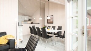 A modern kitchen with white cabinets and stainless steel appliances. - Skandinavisches Haus fur 10 (Grossenbrode)