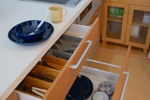 A kitchen drawer with utensils and cookware. - Glowlight 201 - 4-Bedroom Family Suite - 2-Minute Walk to Kuromon Market (Osaka)