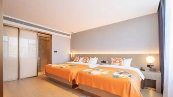 Habitación de hotel con dos camas, una mesita de noche, una lámpara y una puerta corredera.