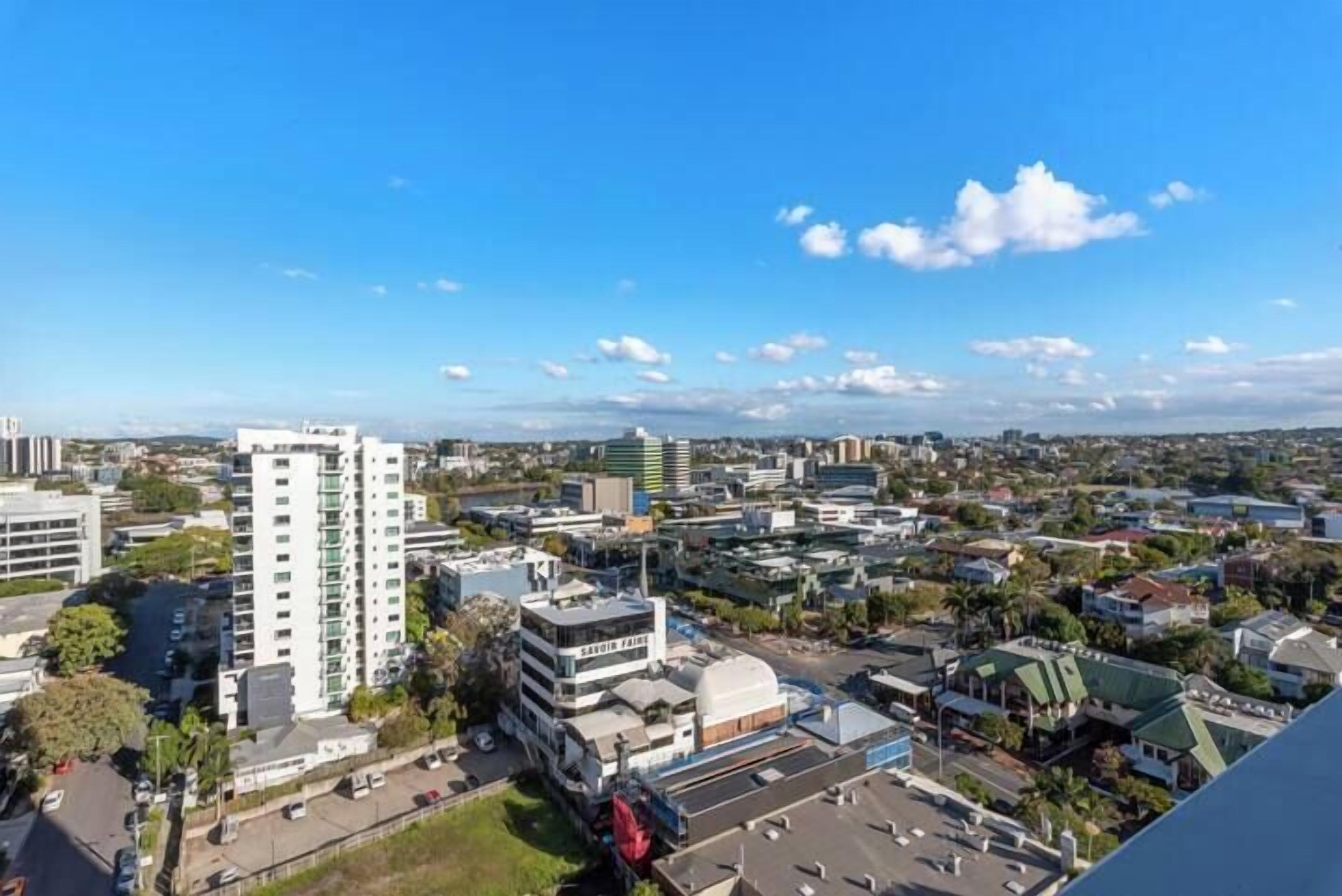 A cityscape with buildings, roads, and a clear sky.