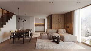 Ein modernes Interieur mit einer Holztreppe, einem Essbereich, einer Küche und einer Sitzecke mit Blick.