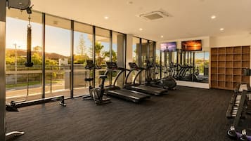A gym with treadmills, stationary bikes, and weight machines.