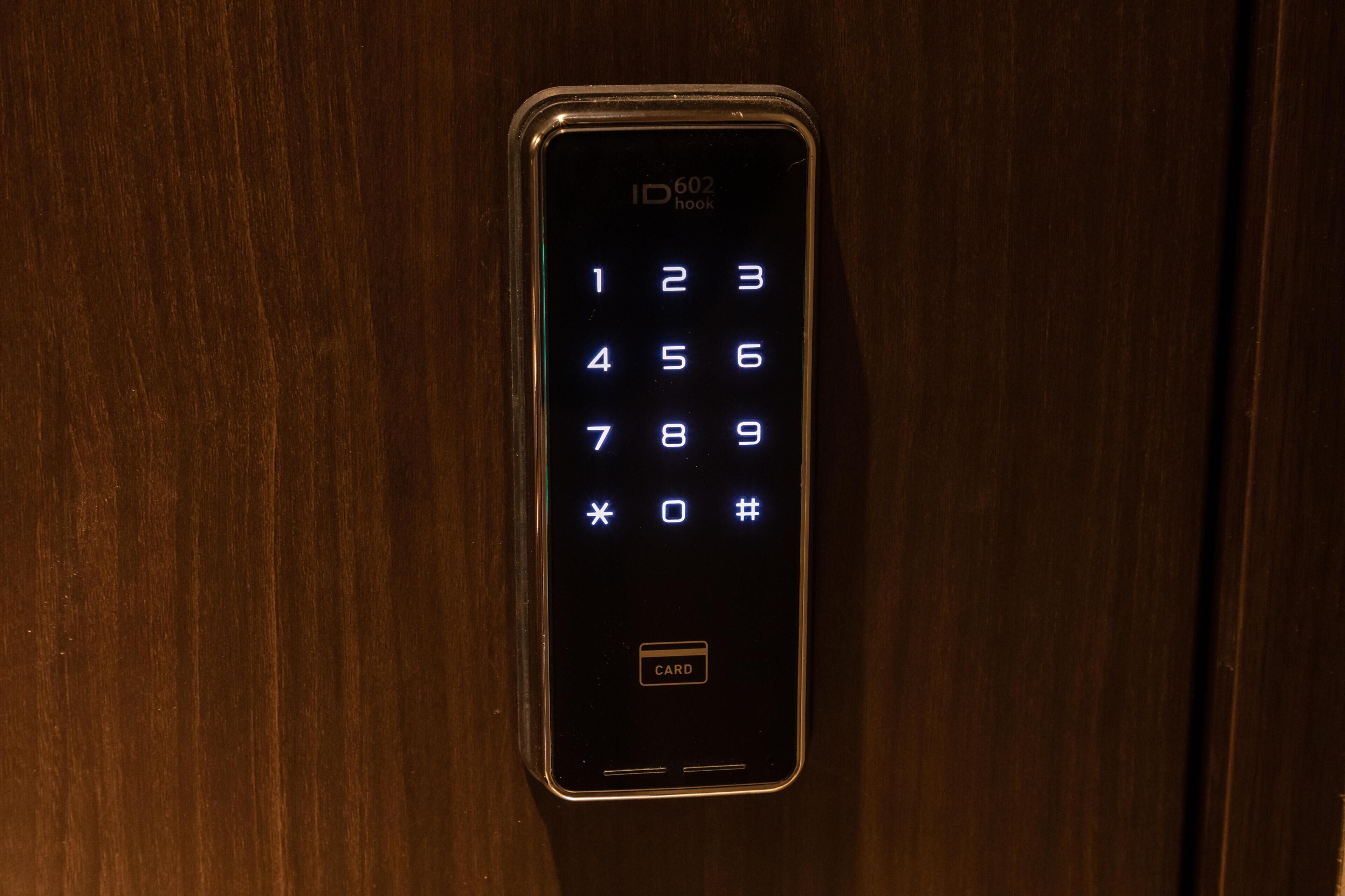 A numeric keypad on a door, likely for a hotel room entry system.