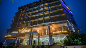 A multi-story hotel with a prominent 'Lace Boutique Hotel' sign.