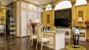 A luxurious hotel lobby with marble flooring, a central desk with chairs, a television, and decorative elements. - Sunday- Johor Bahru Near Mid Valley Southkey Formally Lace Boutique (Johor Bahru)