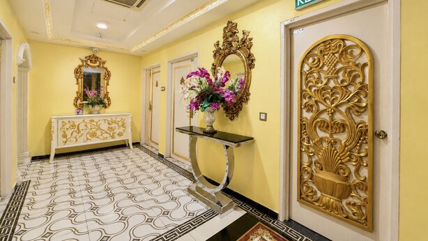 A hallway with a yellow wall, a white door with a gold design, and a sign reading 'KELUAR'. - Sunday- Johor Bahru Near Mid Valley Southkey Formally Lace Boutique (Johor Bahru)