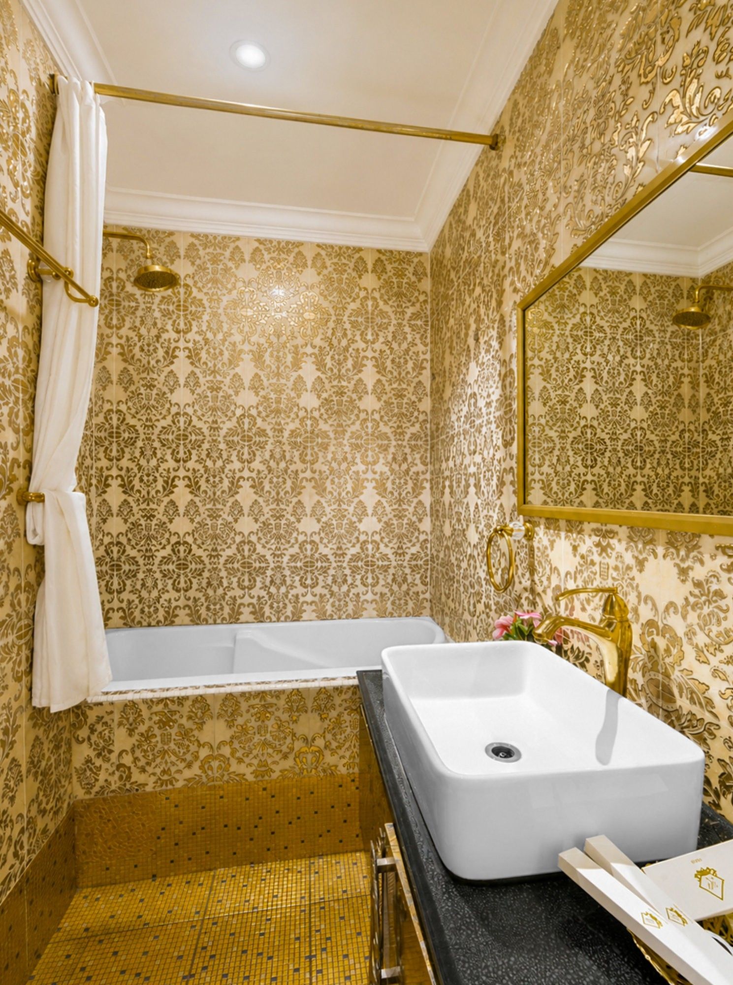 A bathroom with a bathtub, a sink, and a mirror.