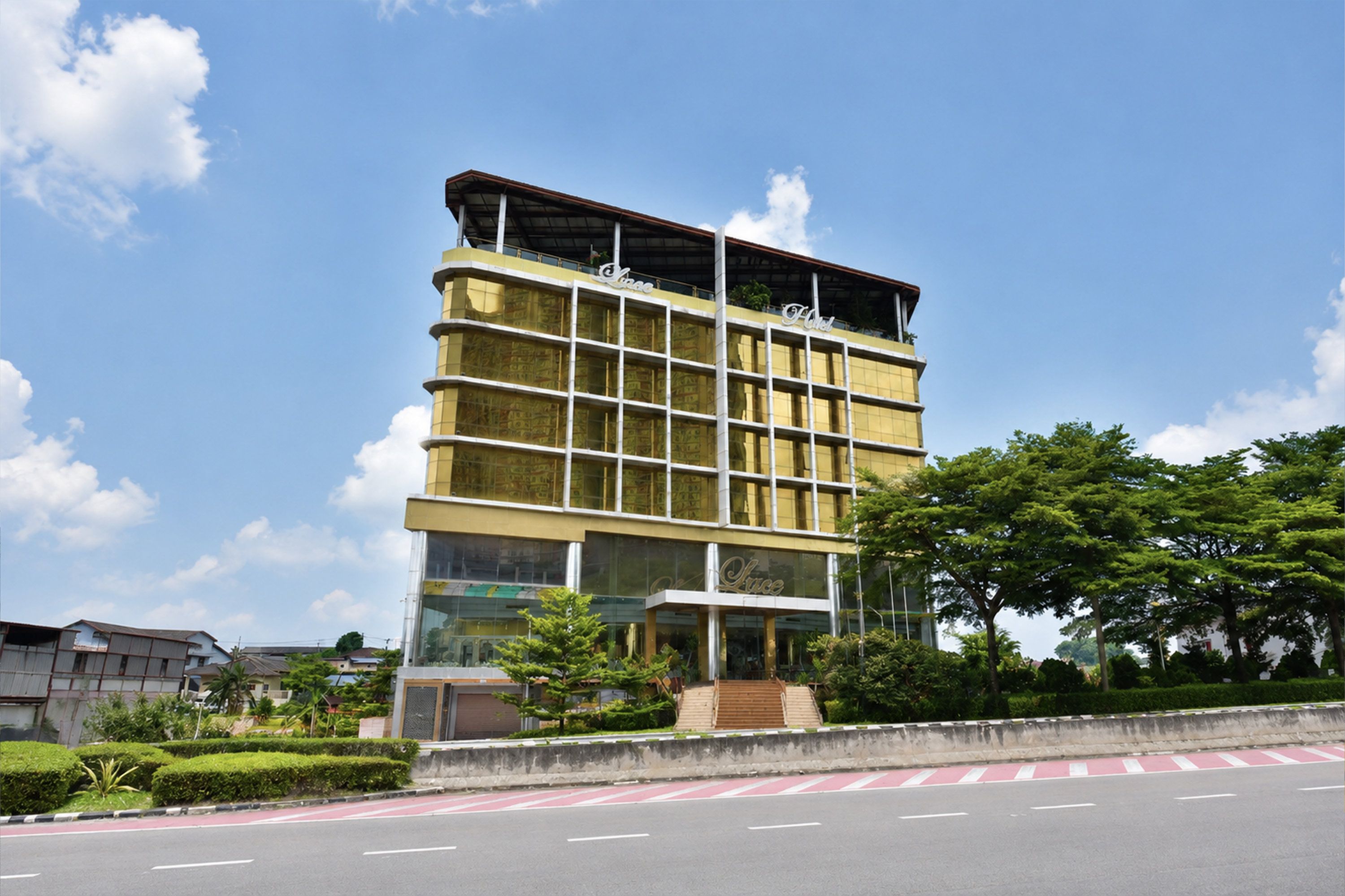 A multi-story hotel with a modern design, featuring a prominent entrance with a staircase and a large glass facade.