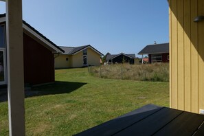 Een woonwijk met meerdere huizen, een gazon en een heldere lucht.