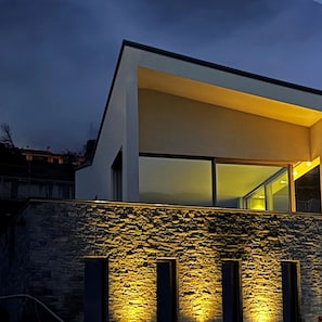 A modern building with a stone facade and large windows. - Villa Aqua by Elite Villas (Tremezzina)