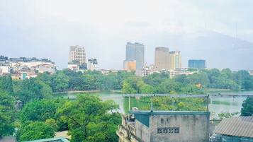 A cityscape with a river, buildings, and greenery.