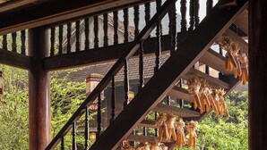 A wooden staircase with a view of hanging corn cobs.