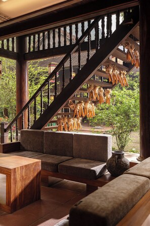 A wooden staircase with a view of hanging corn cobs.